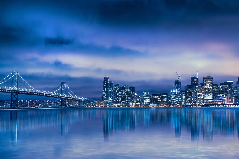 A nighttime photo of the Golden Gate Bridge and the San Francisco skyline.