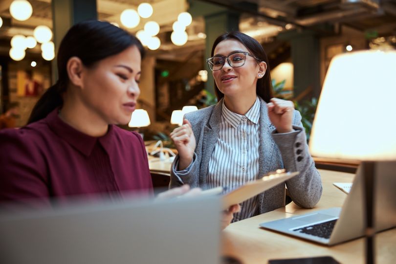 two women talking at work