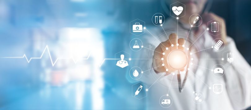 Health professional reaches out to touch an overlay of networked health data images.