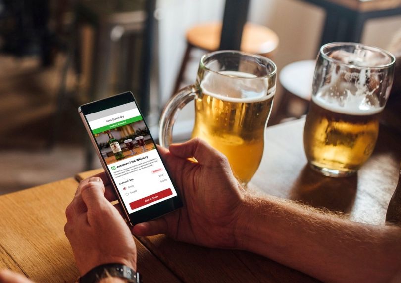 A customer orders a whiskey using the Union app.