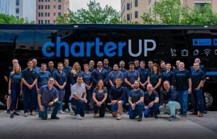 CharterUP staff in front of a CharterUP bus